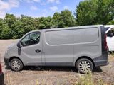 a van that is parked in a lot next to other cars