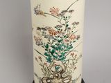a vase with a design of flowers and birds on it