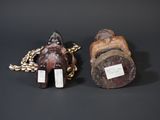 pair of carved figurines of a man and a woman on a chain