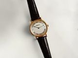 an image of a close up of a wrist watch on a white surface