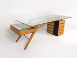 une photo d'un bureau avec un plateau en verre et des pieds en bois