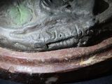 a close up of a statue of a shoe on a pedestal