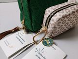 the small cosmetic bag is green and has a leopard print pattern on it
