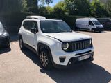 a white jeep parked in a parking lot next to other cars