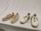 three pairs of sneakers are lined up on a table