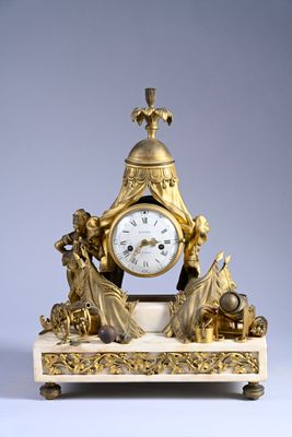 a gold clock sitting on top of a marble table