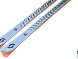 pair of skis sitting on top of each other on a white surface