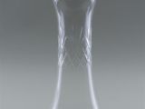 a clear glass vase with a black lid on a table