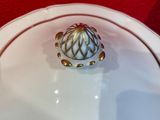 a white plate with a gold ring on top of it