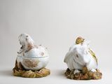 two figurines of animals sitting on top of each other