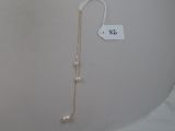 a picture of a necklace with pearls hanging from it