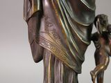 a bronze statue of a woman holding a child