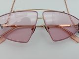 sunglasses hanging on a chain on a white surface