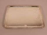 silver plated tray with handle and handles on a table