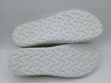 a close up of a pair of white shoes on a white surface