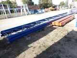 a large long metal structure sitting on the ground