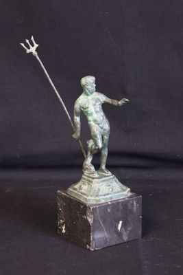 bronze statue of a man holding a spear on a marble base