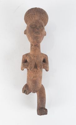 an old wooden figurine of a woman with a hat on her head