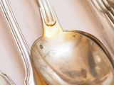 two spoons and a spoon rest on a table
