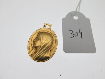 un gros plan sur une médaille d'or à laquelle est accrochée une étiquette