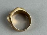 an image of a gold ring on a white surface