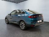 the rear end of a blue car in a showroom