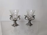 two glass goblets sitting on a glass table