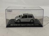 toy car in a clear display case on a white surface