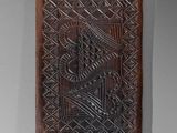 a close up of a piece of wood with a design on it