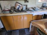 a cluttered kitchen with a lot of clutter on the counter