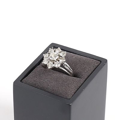 une image représentant une bague en diamant dans un écrin noir sur fond blanc