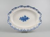blue and white platter with blue flowers on it on a stand