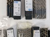 many different types of drill bits on the table