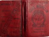 an old red book with a stamp on it sitting on top of a table