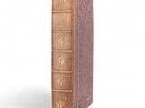 an old book sitting on top of a table next to a white background