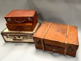 three suitcases stacked on top of each other on a table