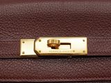 a brown leather handbag with a gold lock on it