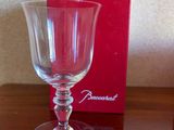 a wine glass sitting on a table next to a red box