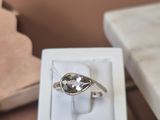 a white box with a silver ring in it on a table