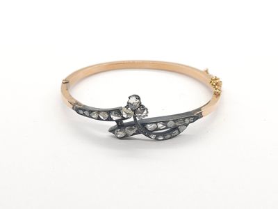 a close up of a gold and diamond ring on a white background