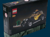 a black and yellow toy car in a black box