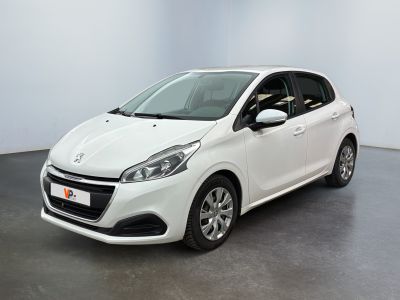 La voiture blanche est garée dans une grande pièce.