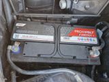 two batteries in the back of a car