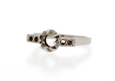 a close up of a silver ring with skulls on it