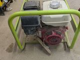 an image of a green and white machine in a garage
