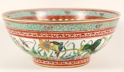 a colorful bowl with birds on it on a white surface