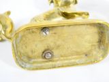 a gold statue of a dog on a white background