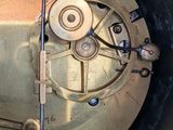 a close up of a clock that is on a table
