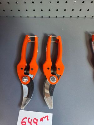 three orange pliers on display in a store