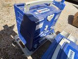 a blue cart and a blue and white box on the ground